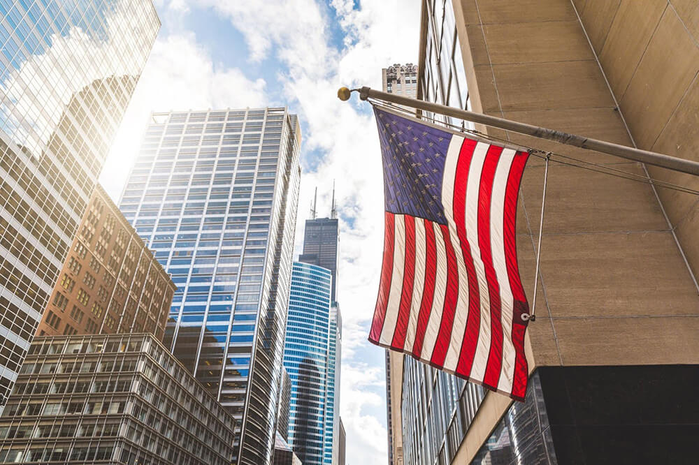 USA flag with skyscrapers on background